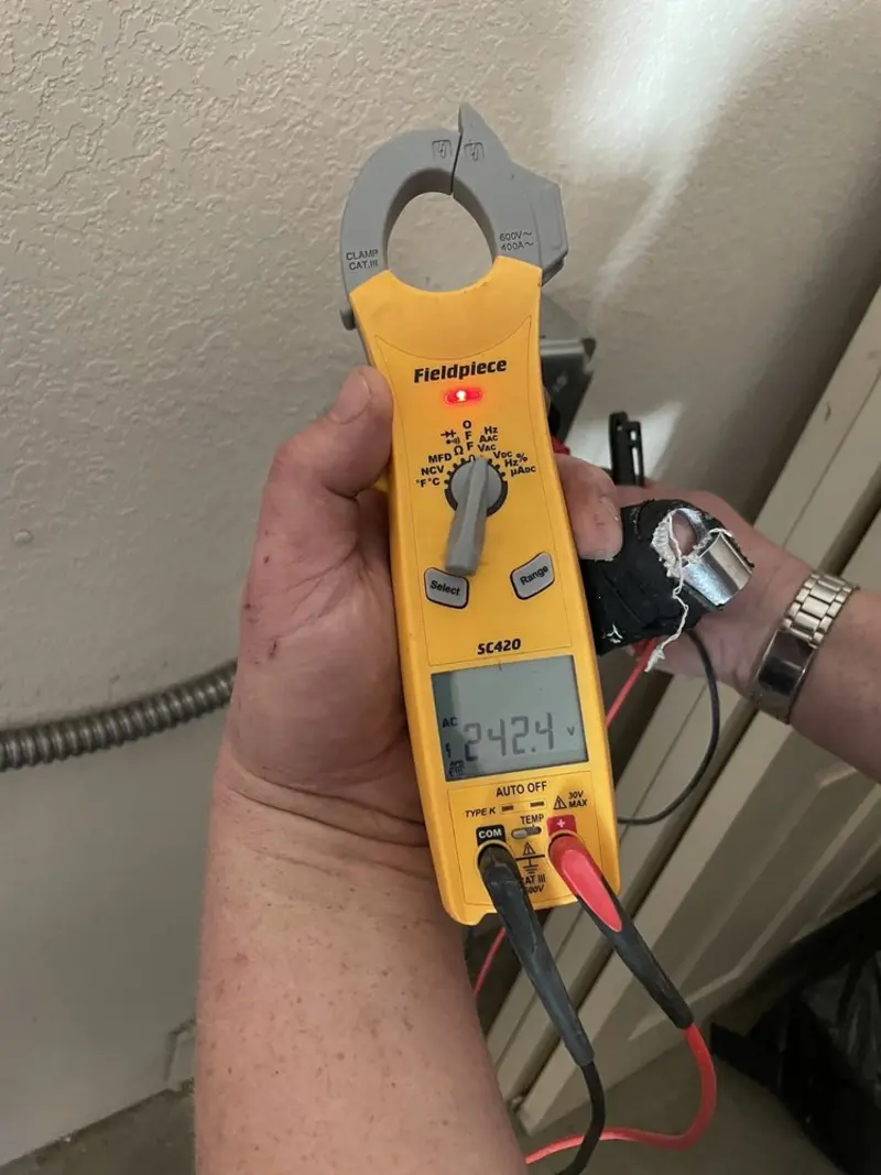 Voltage testing with clamp meter during Outlet Installation in Beaver